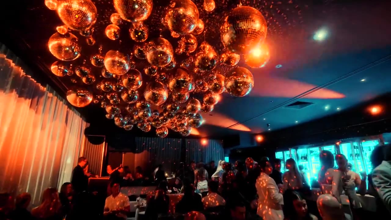 Mirror ball ceiling over a packed room